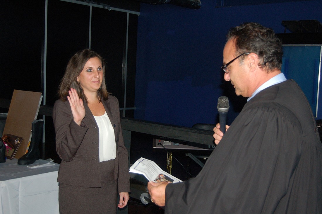 Alexandria Hill was sworn in June 8 as president of The Jacksonville Bar Association Young Lawyers Section by Duval County Judge Gary Flower.