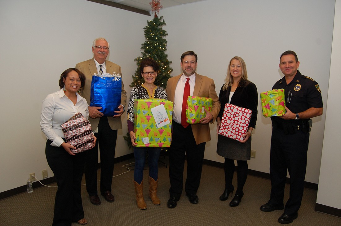 Jacksonville Bar Association Senior Holiday Project Chair Kimberly Jones, Duval County Judges Roberto Arias and Eleni Derke, JBA President Tad Delegal, President-elect Katie Dearing and Sheriff Mike Williams.
