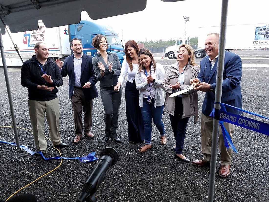 From left, Zach Fox, Chris Sloope, Lisa Diaz, Grisel Rodriguez, Ivanna Fox, Maria Fox and CEO Robert Fox cut the ribbon at the grand opening for North Florida Warehouse FTZ.  Diaz is with Jaxport.