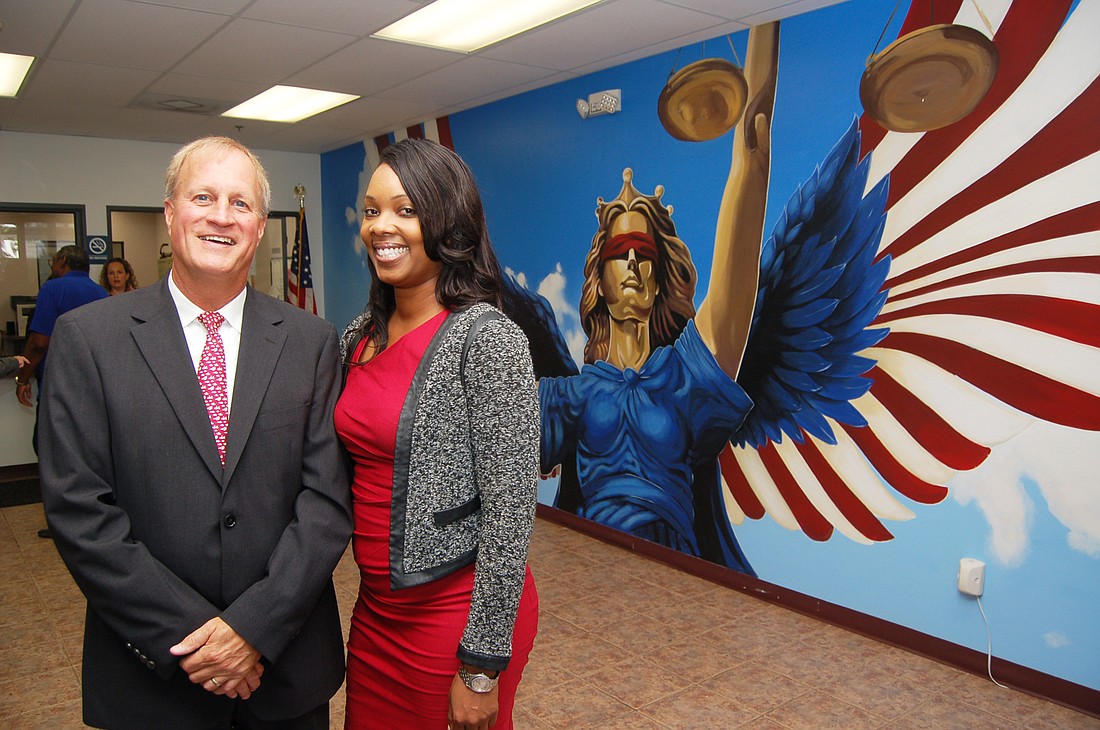 Jacksonville Area Legal Aid Chief Development Officer Dennis Harrison and board Chair Ramona Chaplin and the new mural.