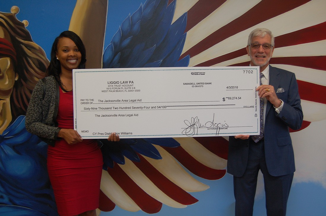 JALA board Chair Ramona Chaplin accepted a $69,274.54 donation presented by attorney Jeff Liggio that was a portion of the funds remaining after a settlement was disbursed to plaintiffs in a class-action lawsuit.
