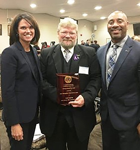 From left, State Attorney for the 4th Judicial Circut Melissa Nelson; Carl Harms, recipient of the 2018 Distinguished Victim Services Award; and Ernest Edwards, assistant chief investigator in the state attorney&#39;s office.