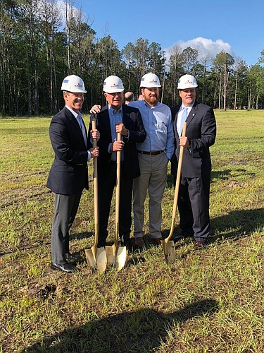 From left, JAX Chamber President Daniel Davis, Champion Brands CEO Earl Benton, General Manager Jacob Benton and state Sen. Aaron Bean after a ceremonial groundbreaking Tuesday for Champion Brands headquarters offices.
