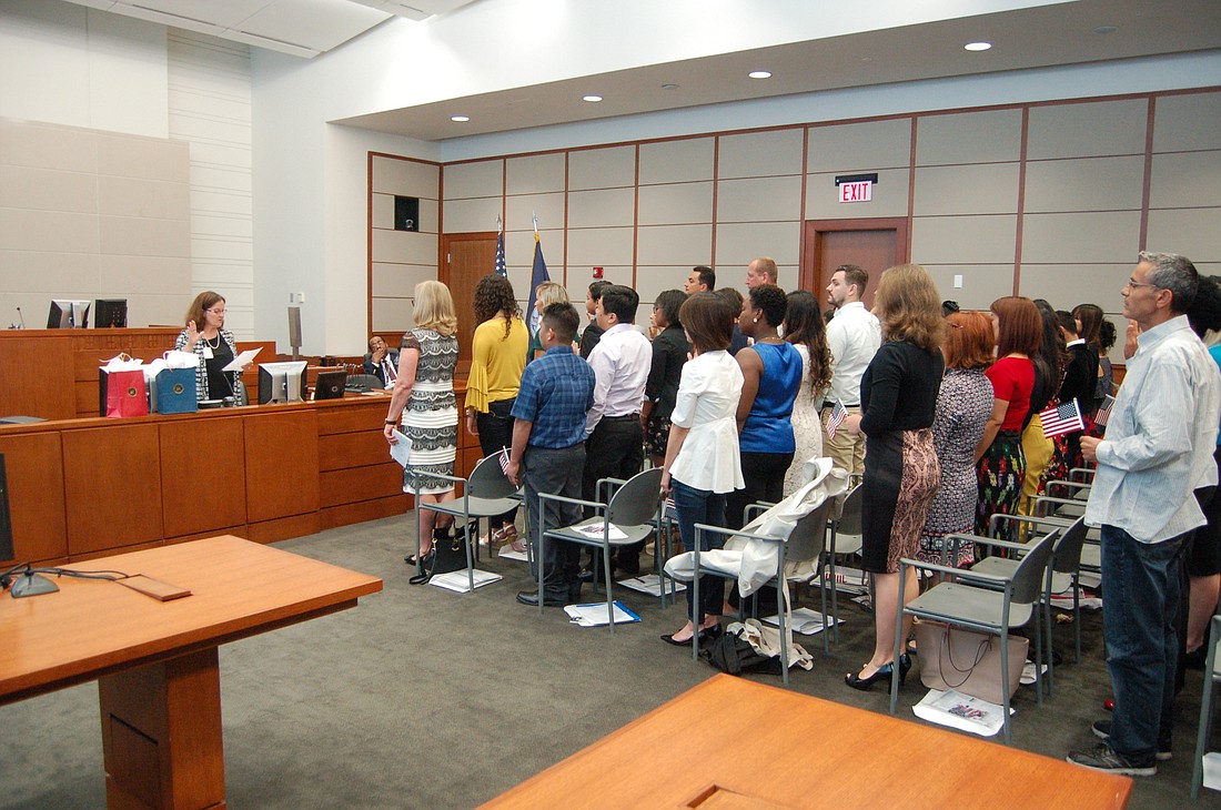 Forty-eight people stood, swore an oath and became American citizens Thursday morning in a courtroom at the Bryan Simpson U.S. Courthouse during the annual Law Week Naturalization Ceremony.