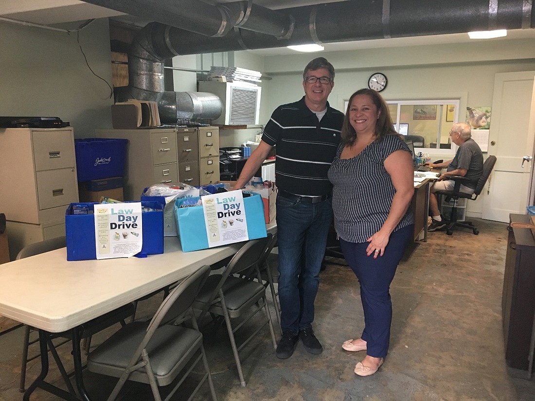 Law Week Art Supply and Toiletries Drive Chair Ingrid Osborn delivered donations to Downtown Ecumenical Services Executive Director David Clark.