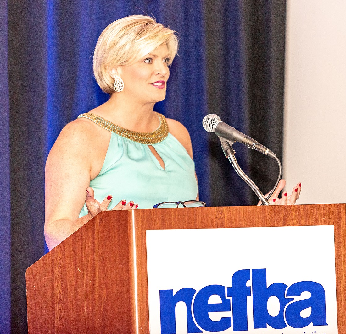 Local television personality, Nikki Kimbleton of WJXT TV-4, keeps the presentations going smoothly as NEFBA builders learned who won the gold and silver awards in a number of categories.