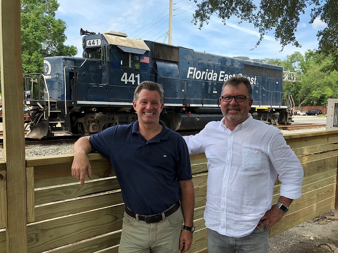 Mark Janasik, left, and Ned Jones expect to open the Southern Grounds coffee shop at 1671 Atlantic Blvd. this week. It sits along railroad tracks, providing daily entertainment as locomotives and trains pass by.
