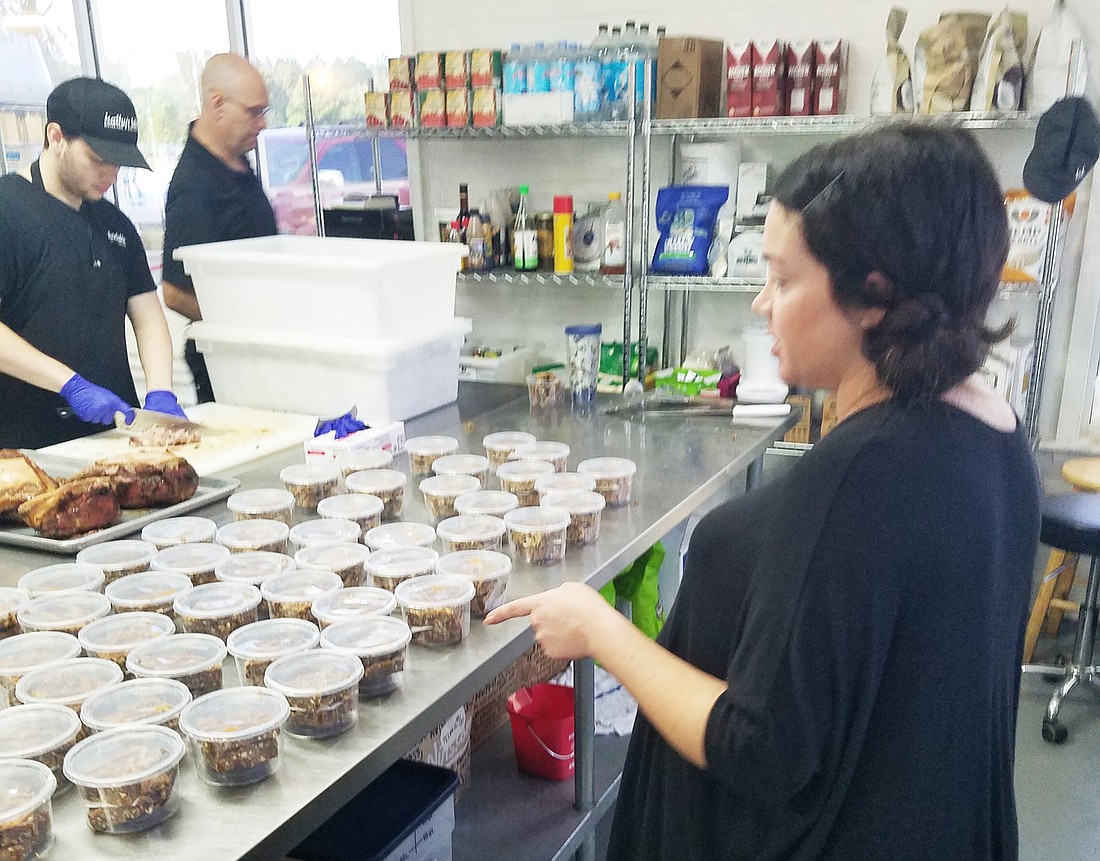 Kathy Godwin, who started the Kathyâ€™s Table home food delivery business in her house about four years ago, oversees production at her companyâ€™s store at 7035 Philips Highway,