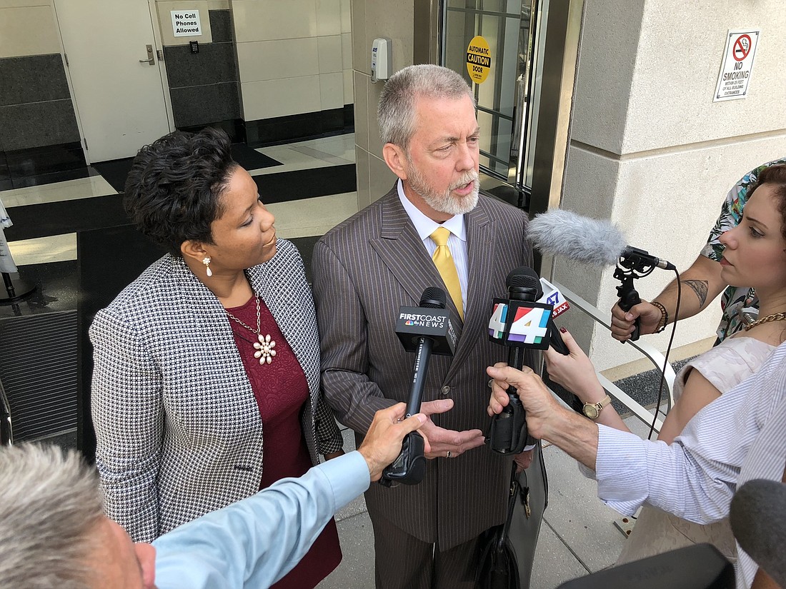 Suspended City Council member Katrina Brown and her former attorney, Curtis Fallgatter, address the media following an appearance in federal court Thursday. Brown will proceed with a court-appointed counsel.