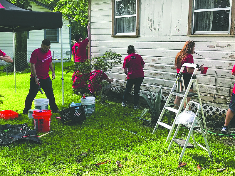 Volunteers from Wells Fargo complete an exterior paint job on a Jacksonville home in partnership with Builders Care, whose mission is to repair and restore housing for the elderly, veterans, disabled homeowners.