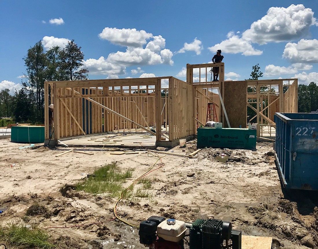 Construction employees work on erecting new Lennar homes in the Osprey Landing community in North Jacksonville. Photo by Jay Schlichter