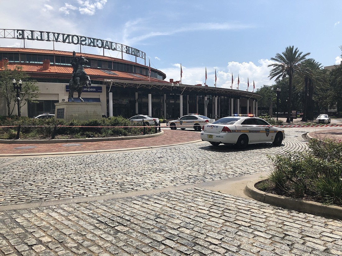 Jacksonville Sheriff&#39;s Office vehicles surround the Jacksonville Landing after a suspect, or suspects, killed at least four people and injured several more during a video game tournament.  Photo by David Cawton