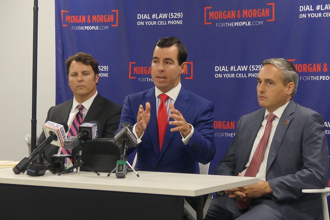 From left, Morgan & Morgan attorneys Timothy Moran, Matt Morgan and James Young announced Tuesday the law firm plans to file lawsuits later this week on behalf of clients who were injured Sunday in the shooting at the Landing.