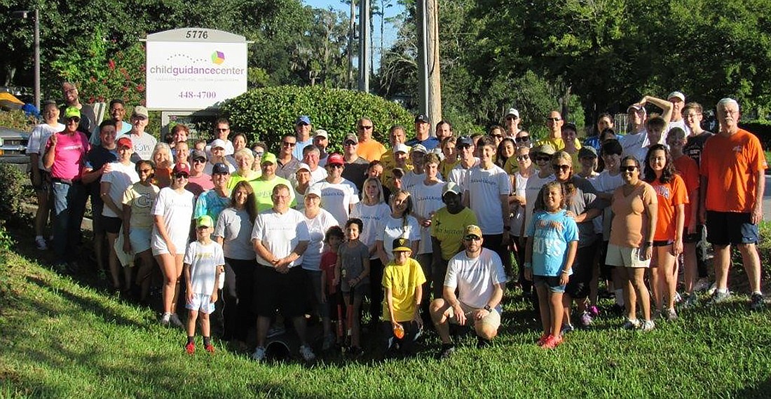 More than 100 Holland & Knight volunteers painted and did landscaping at the Child Guidance Center.