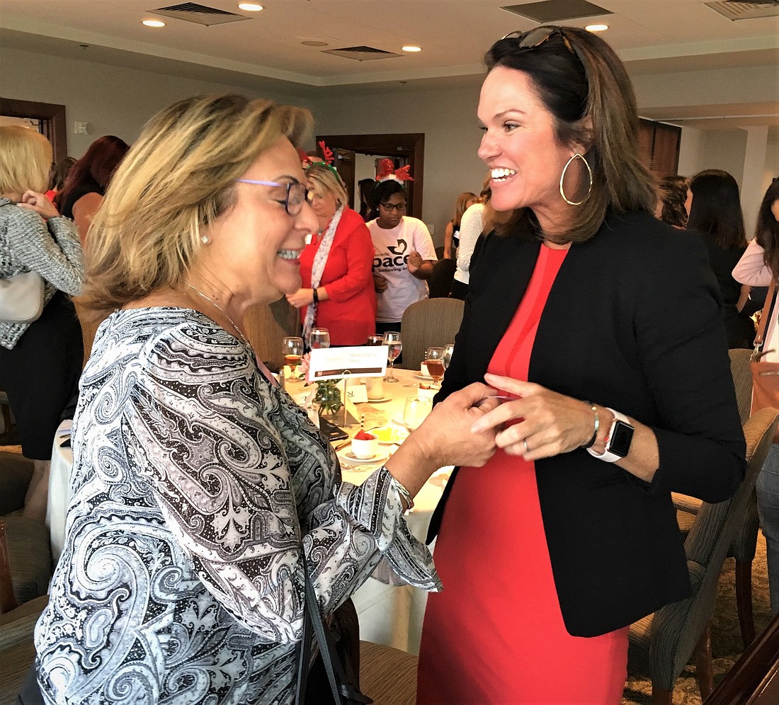 State Attorney Melissa Nelson, right, talks with Marie Watson, vice president of commercial lending at FirstAtlantic Bank, afterÂ the CREW Jacksonville meeting Sept. 11.