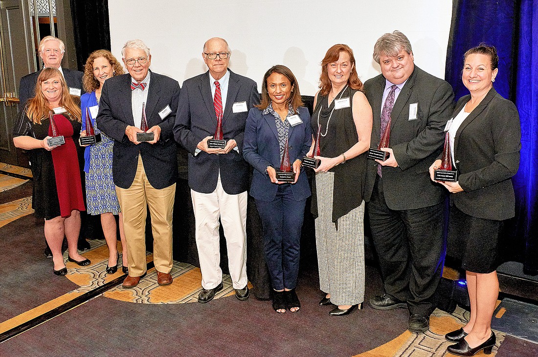 Outstanding pro bono service honorees, from left, Circuit Judge Hugh Carithers, Tania Schmidt-Alpers, Jeanine Sasser, Douglas Milne, John Humes Jr., Crystal Freed, Debbie Lee Clark, Rusty Collins and Lisa DiFranza.