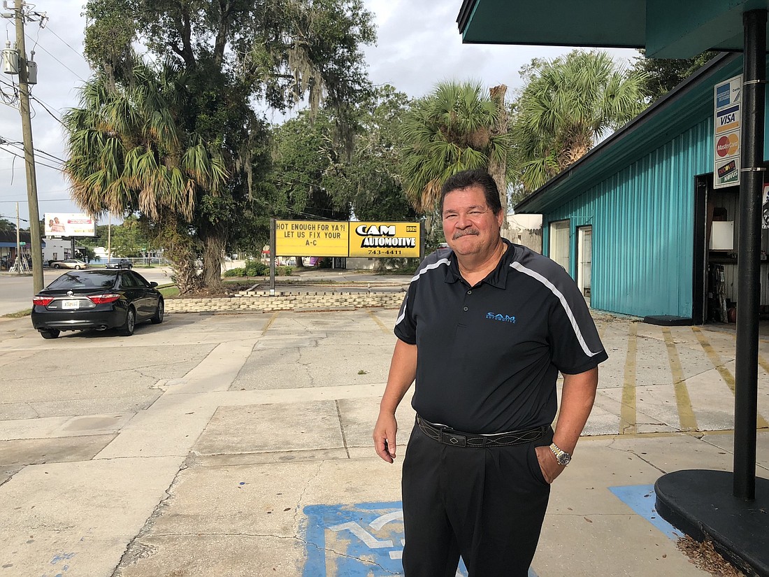 Mike Anania, owner of Cam Automotive along Arlington Road, said it would cost his shop â€œhundreds of thousands of dollarsâ€ because proposed new rules would ban open bay doors that face the street.