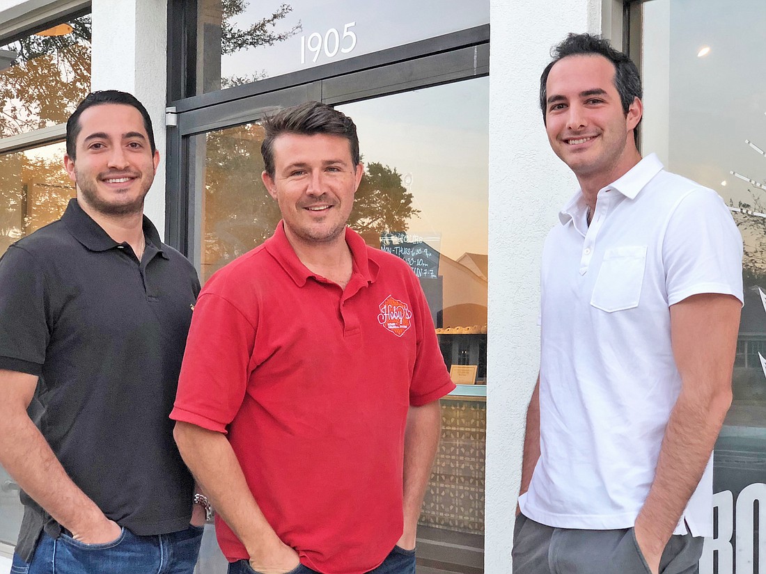 Paul and Louis Sleiman, left and right, with Ryan Hoback, owner of Hobyâ€™s Honey & General Store. The Sleimans and Hoback found themselves at odds in 2017 when the brothers bought the shopping center where Hoback was a tenant.