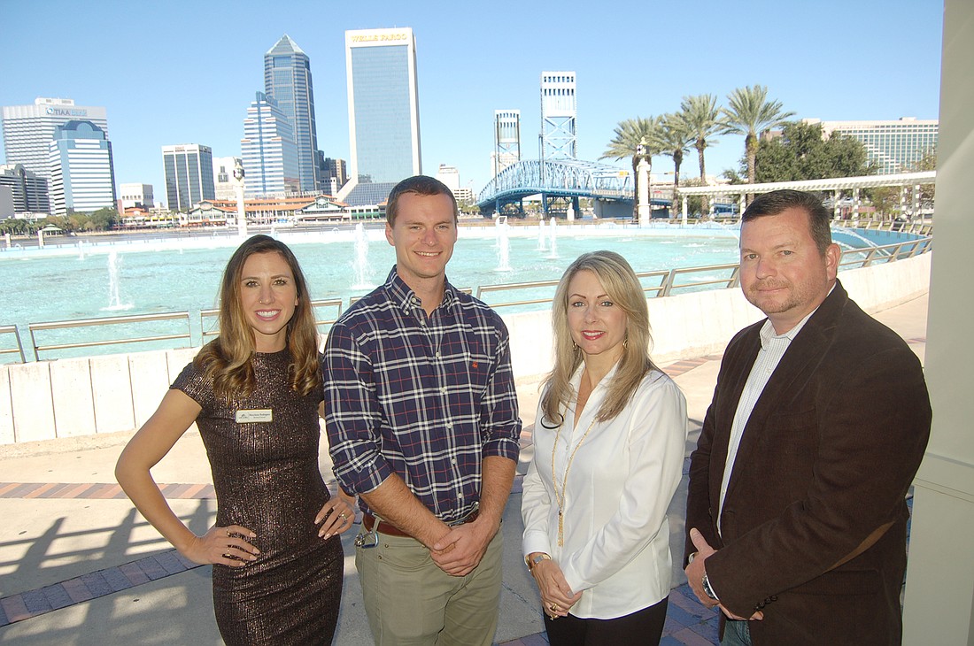From left to right, MaryAnne Rodriguez, Nick Kausch, Lynn Mattingly and Jason Beard pose for a photo at Friendship Fountain in Jacksonville&#39;s Southbank. Photo by Jay Schlichter