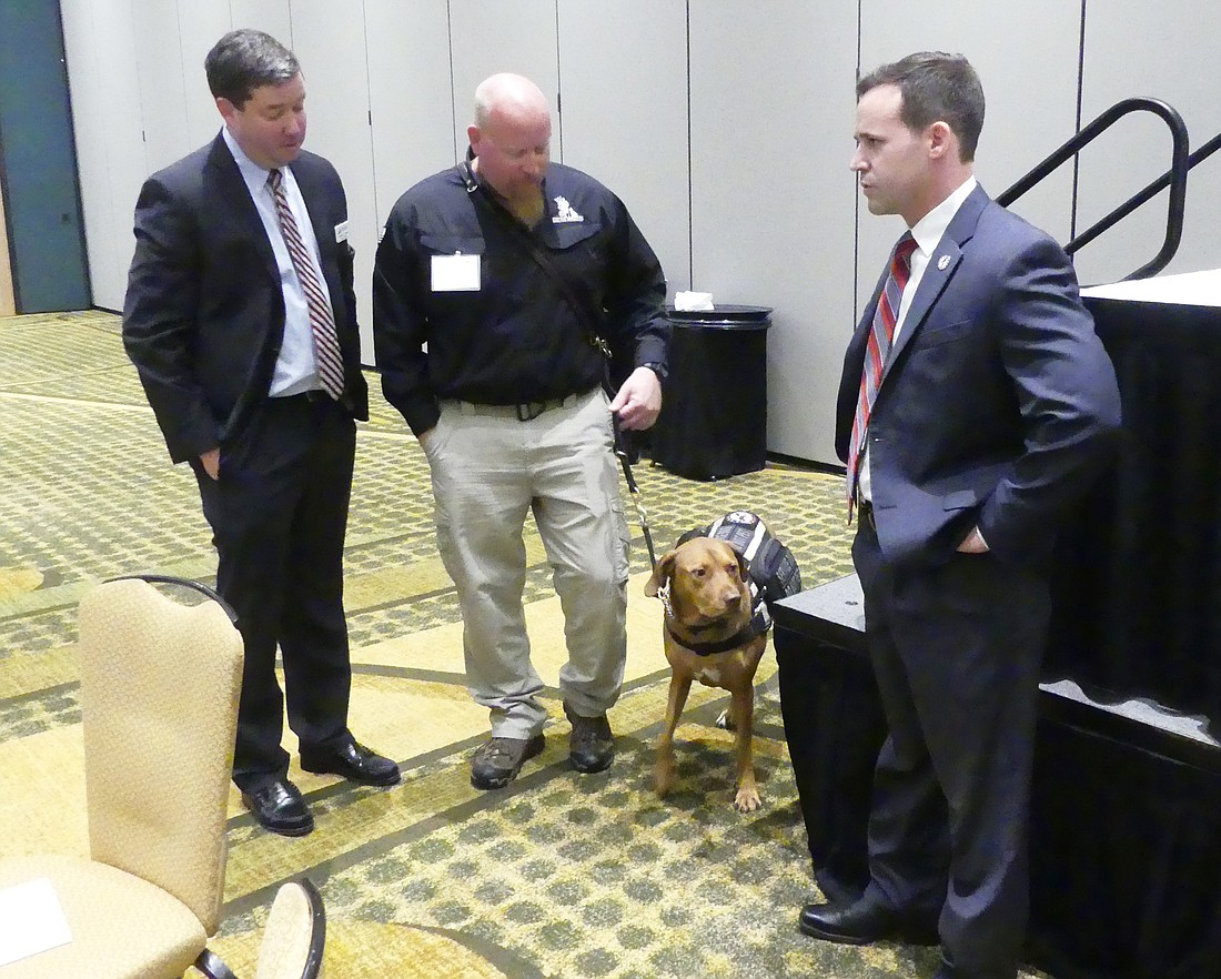 Christian George, JBA board member and president of The Florida Bar Young Lawyers Division; Greg Wells, Army veteran and K9s For Warriors trainer; service dog Utah; and K9s For Warriors CEO  CEO Rory Diamond.