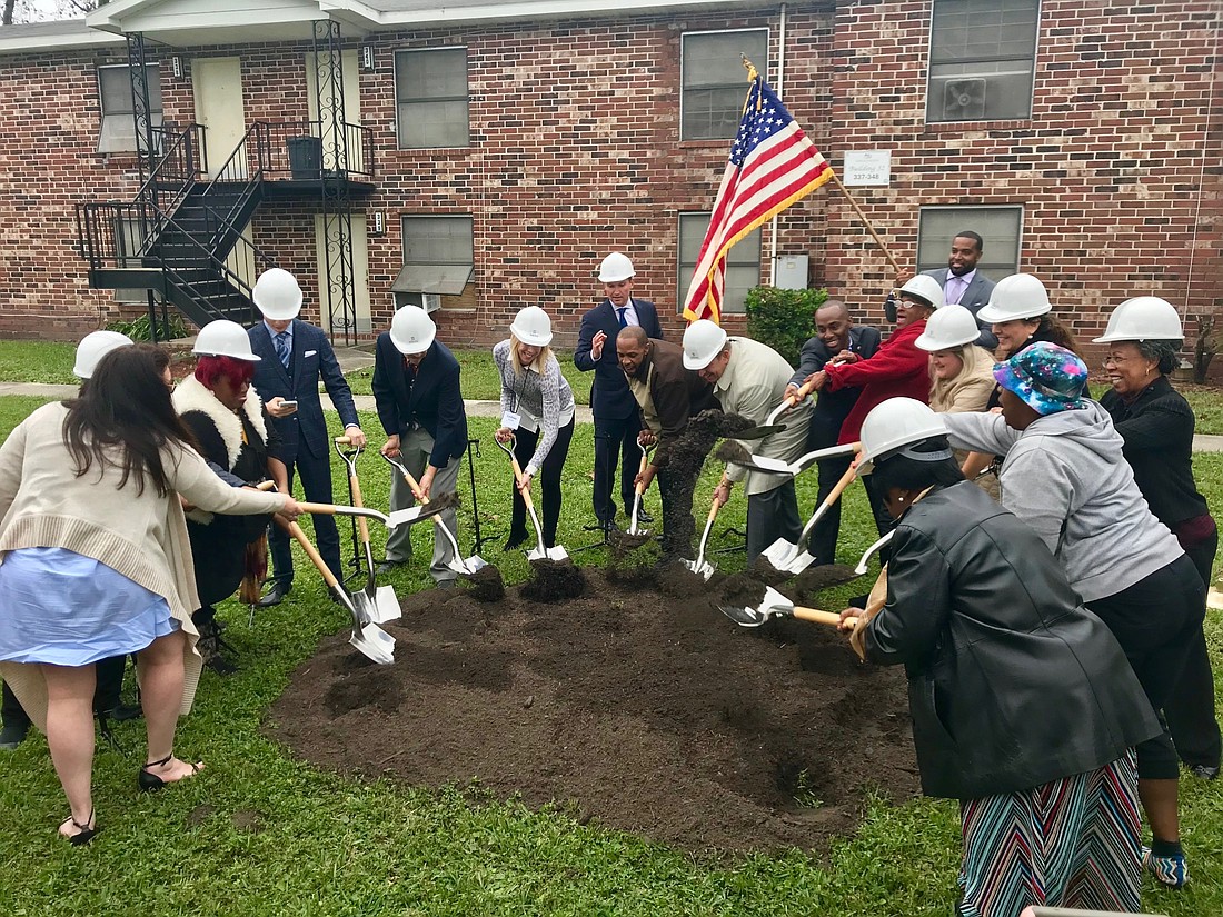 Officials take part in a groundbreaking Thursday for renovations at the Eureka Gardens apartments in West Jacksonville.