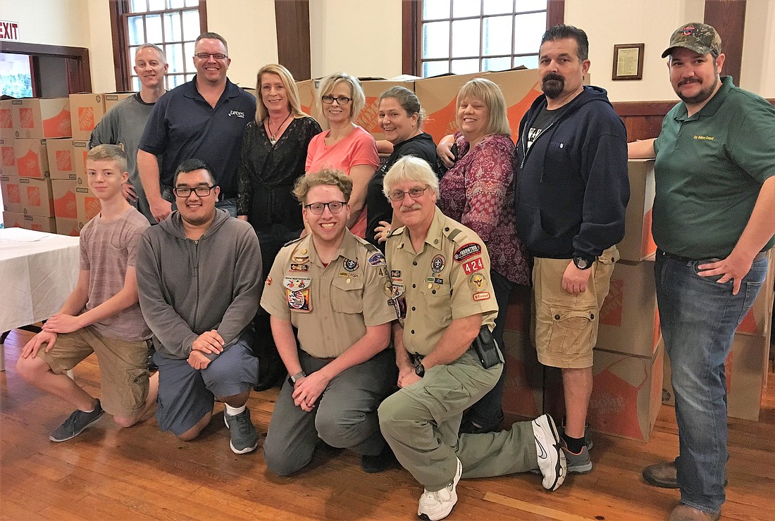 A dozen volunteers, members of the Clay Builders Council and Boy Scout Troop 424, filled 100 boxes with nonperishable food in 45 minutes.