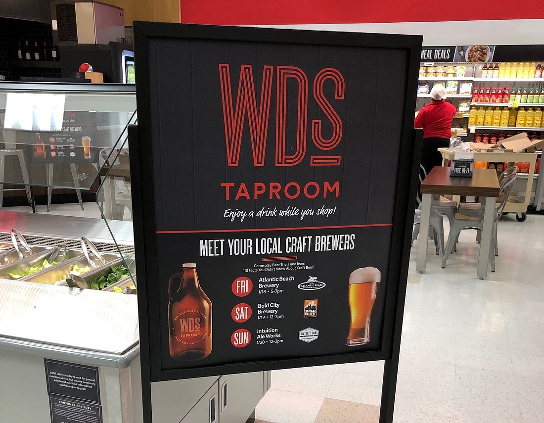 A sign advertises The WD&#39;s Taproom inside the Neptune Beach Winn-Dixie.