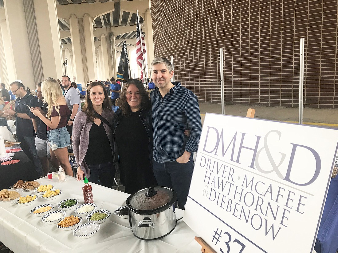 From left, Driver, McAfee, Hawthorne & Diebenow attorneys Amanda Thomas, Cyndy Trimmer and Zach Lever at the law firmâ€™s booth at the 2018 Young Lawyers Section Charity Chili Cook-Off.
