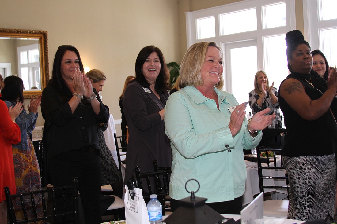 Legends of Real Estate Realtor Gerri Landrum, center, applauds at the Womenâ€™s Council of Realtors luncheon Feb. 21 at Deercreek Country Club.