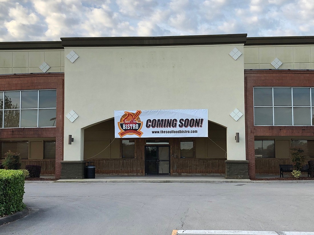 A banner for The Potterâ€™s House Soul Food Bistro hangs outside its upcoming location at 9400 Atlantic Blvd. in the former Outback Steakhouse.