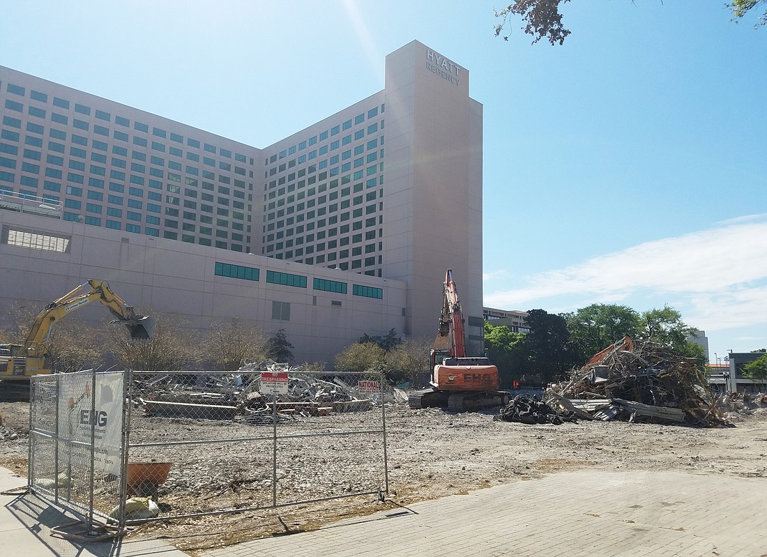Rubble is removed at the former City Hall along East Bay Street.