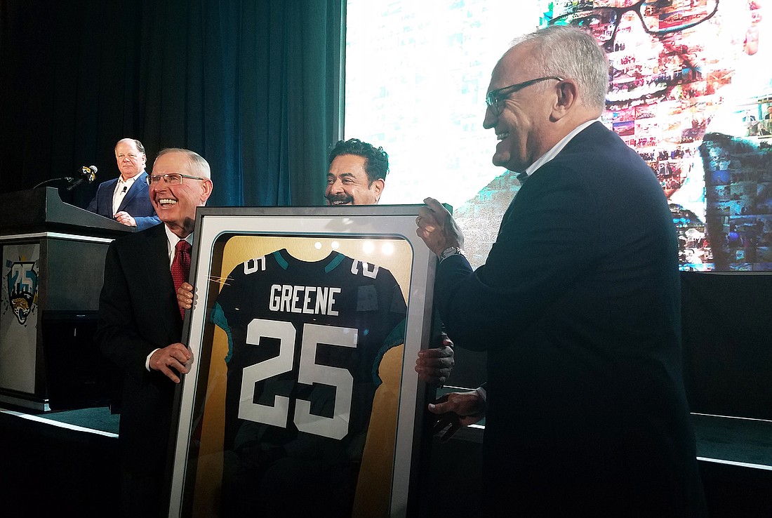 Tom Coughlin and Shad Khan present Hugh Greene with a Jaguars jersey at the State of the Franchise presentation.