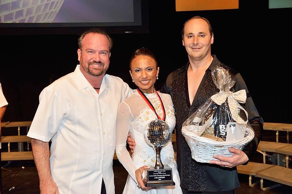 Jacksonville Childrenâ€™s Chorus Artistic Director and President Darren Dailey, attorney Crystal Freed and her professional dance partner, Muhidin Divovic. Freed and Divovic won first place in Jacksonvilleâ€™s â€œDancing with the Stars.â€