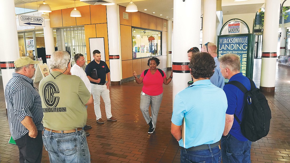 Jacksonville Landing project engineer Nikita Reed talks with demolition contractors during a tour of the shopping mall Thursday. During the tour, officials answered questions about the requirements for the demolition.