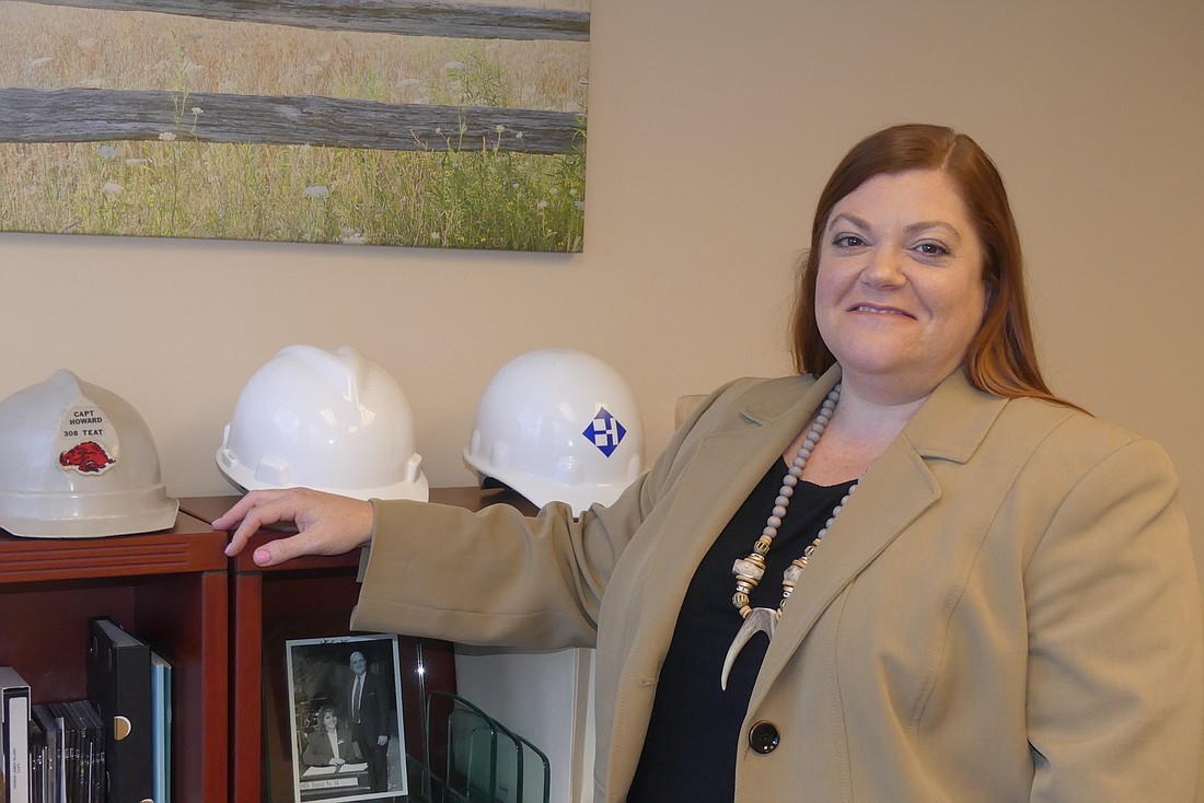 Jacksonville Bar Association President Elizabeth Ferguson has a collection of hard hats in her office because she practices construction law.