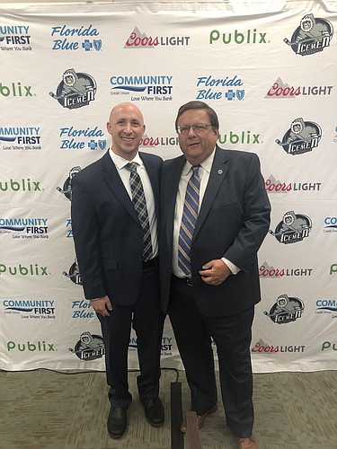 Andrew Kaufmann, the new owner of the Jacksonville Icemen, celebrates with team president Bob Ohrablo during an event Tuesday at JAX Chamber.