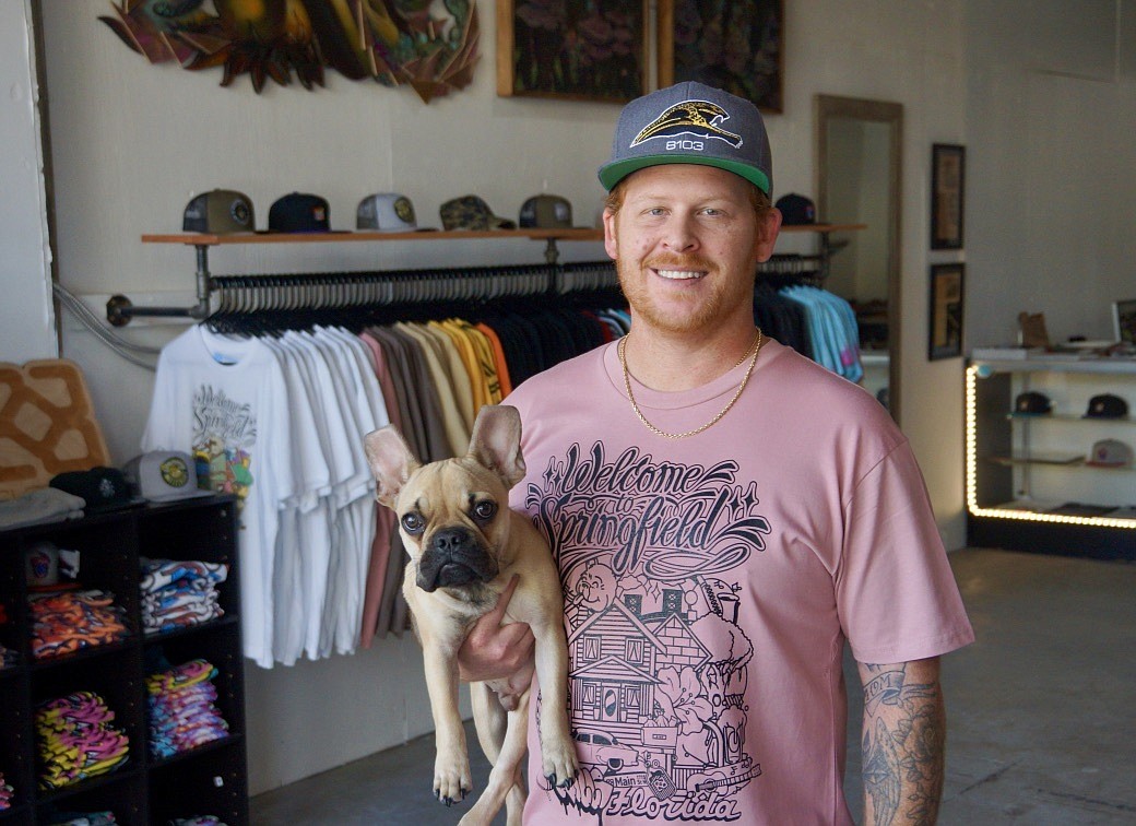 Mark Braddock and his French bulldog, Hank, in 8103 Clothingâ€™s Main Street storefront in Springfield.