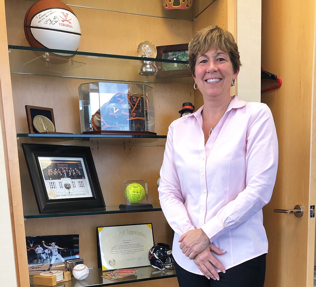 Regency Centers Corp. President Lisa Palmer, who will become the companyâ€™s next CEO in January, shows off her collection of sports memorabilia in her office in the Wells Fargo Center.