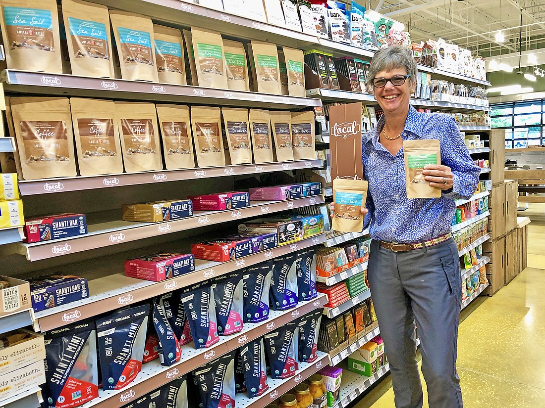 Founder and CEO Anita Comisky with her toffee products in Luckyâ€™s Market. They are sold in stores across the country.