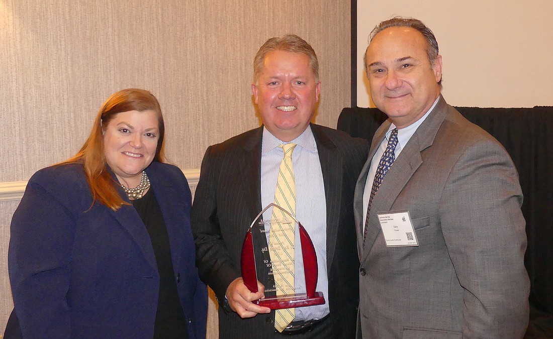 From left, Jacksonville Bar Association President Elizabeth Ferguson, JBA Professionalism Award recipient G. Ray Driver Jr. and Duval County Judge Gary Flower, who presented the award to Driver.
