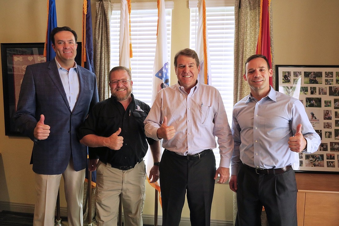 From left, Jed Davis,  president and CEO of DDI, a Davis Family company; Brett Simon, president of K9s For Warriors; Roger Oâ€™Steen, chairman and founder of The PARC Group; and Rory Diamond, executive director of K9s For Warriors.