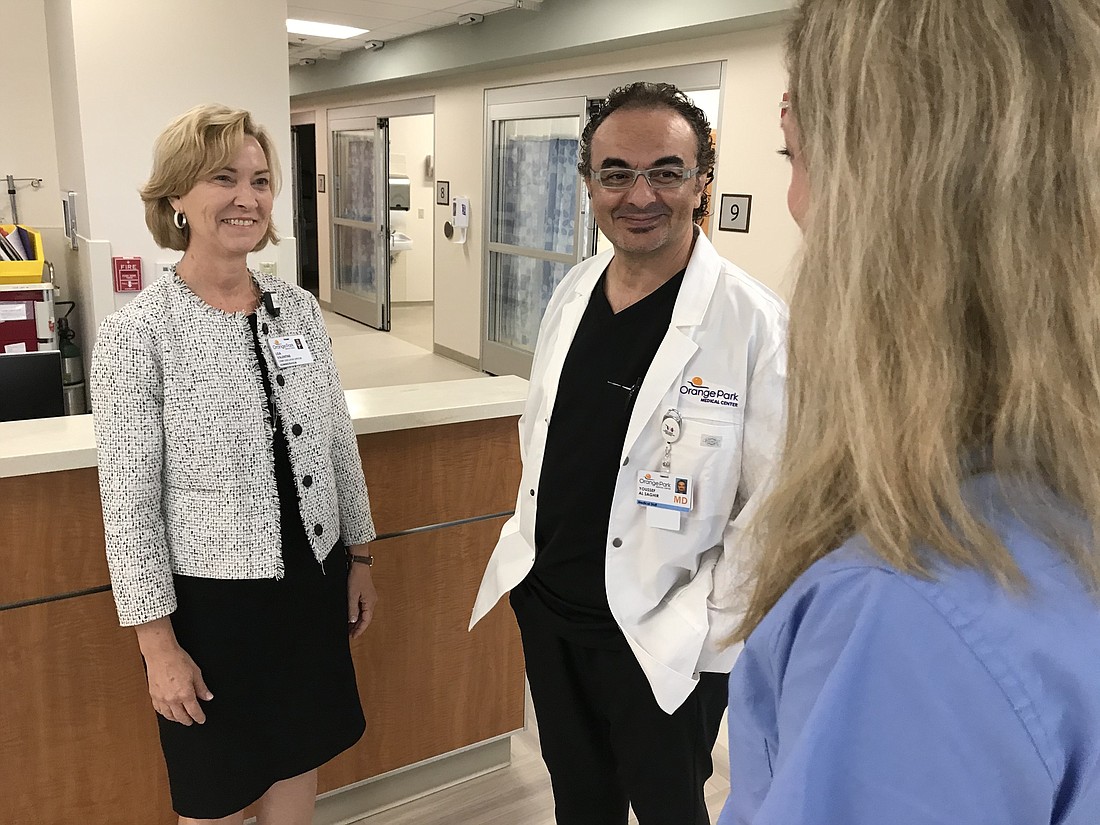 Orange Park Medical Center CEO Lisa Valentine, Dr. Youssef Al-Saghir, an interventional cardiologist, and Laura Duke, director of cardiology services in the hospitalâ€™s electrophysiology lab expansion that opened in July.