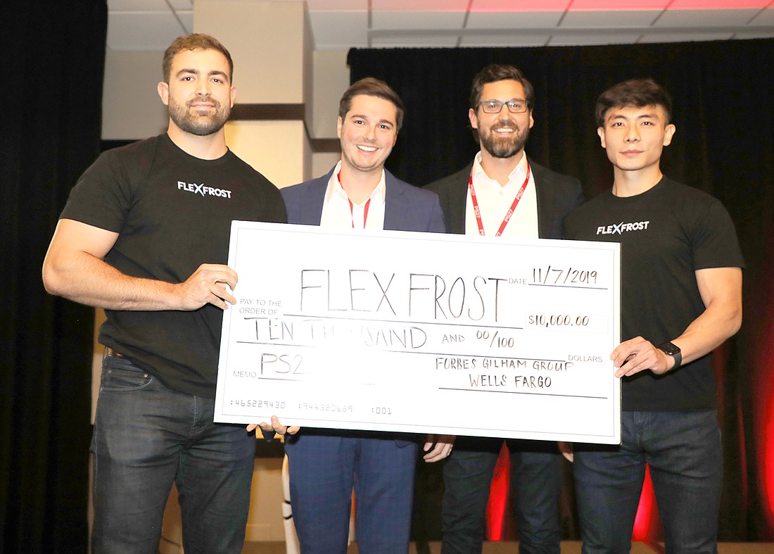 Craig Thomas of Flexfrost, Alexander Intriago and Daniel Gilham of the Forbes Gilham Group and Yang Bai of Flexfrost show off the ceremonial $10,000 check.