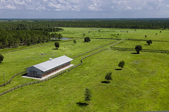 The 2,755 acres of the northwest quadrant of Hutson Ranch include a horse paddock, pictured above, a 50-acre stocked lake and a two-story home built over the lake.