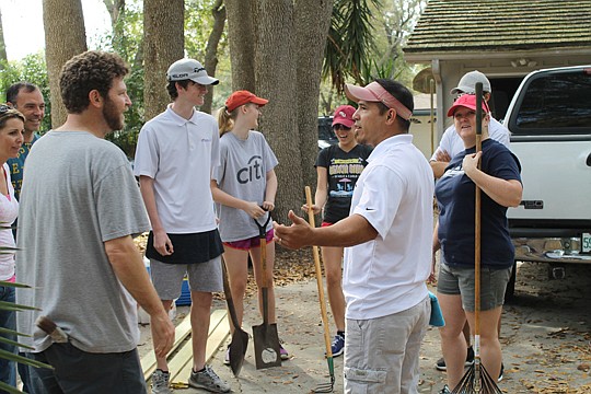 Justin Brown, left, welcomed Mike Bianchi, general manager for Adams Homes, to a Builders Care workday in March. Bianchi brought his home crew to help - his wife Lisa, two daughters and two sons. The team helped paint a group home for Angelwood, a non...