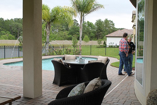 Parade of Homes judges Dale Roberts and Bud Dorman talk before announcing the best feature for ICI Homes' Marabella model in Tamaya.