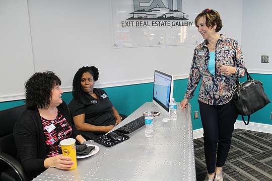 What's it like to run a relocation center? It's like floor duty on steroids, broker Sonny Downey said. At the new real estate office's front desk, which is shaped like an airplane wing, are Janna Thomas of Bank of England, Lisa Brannon of Exit Real Es...