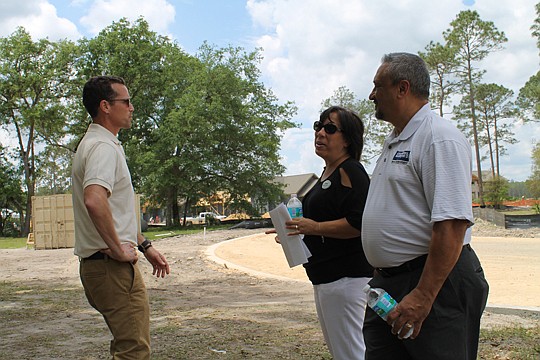 Chris Kuhn, vice president, Land Development for GreenPointe Communities, speaks with Melissa and Michael Daugustinis, both of Coldwell Banker Premier Properties, at TrailMark's April Realtor open house, co-sponsored by GreenPointe and community build...