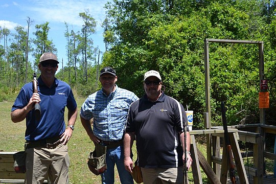 Neil Singleton and Andy Chambers, with MasterCrafter Builders, and Ross McWilliams with Fidelity take a break from sporting clays at the recent Nassau Builders Council event.