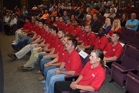 Apprentice graduates in their red logo shirts are honored by friends, family and staff at the ceremony last month.